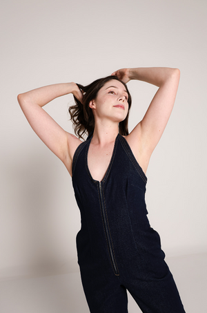 Detalle frontal de overol de mezclilla azul oscuro para mujer con cierre.