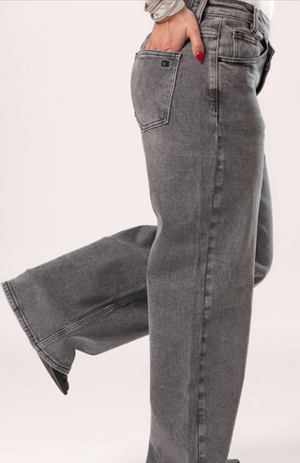 Detalle lateral de pantalon wide leg gris con acabado denim lavado