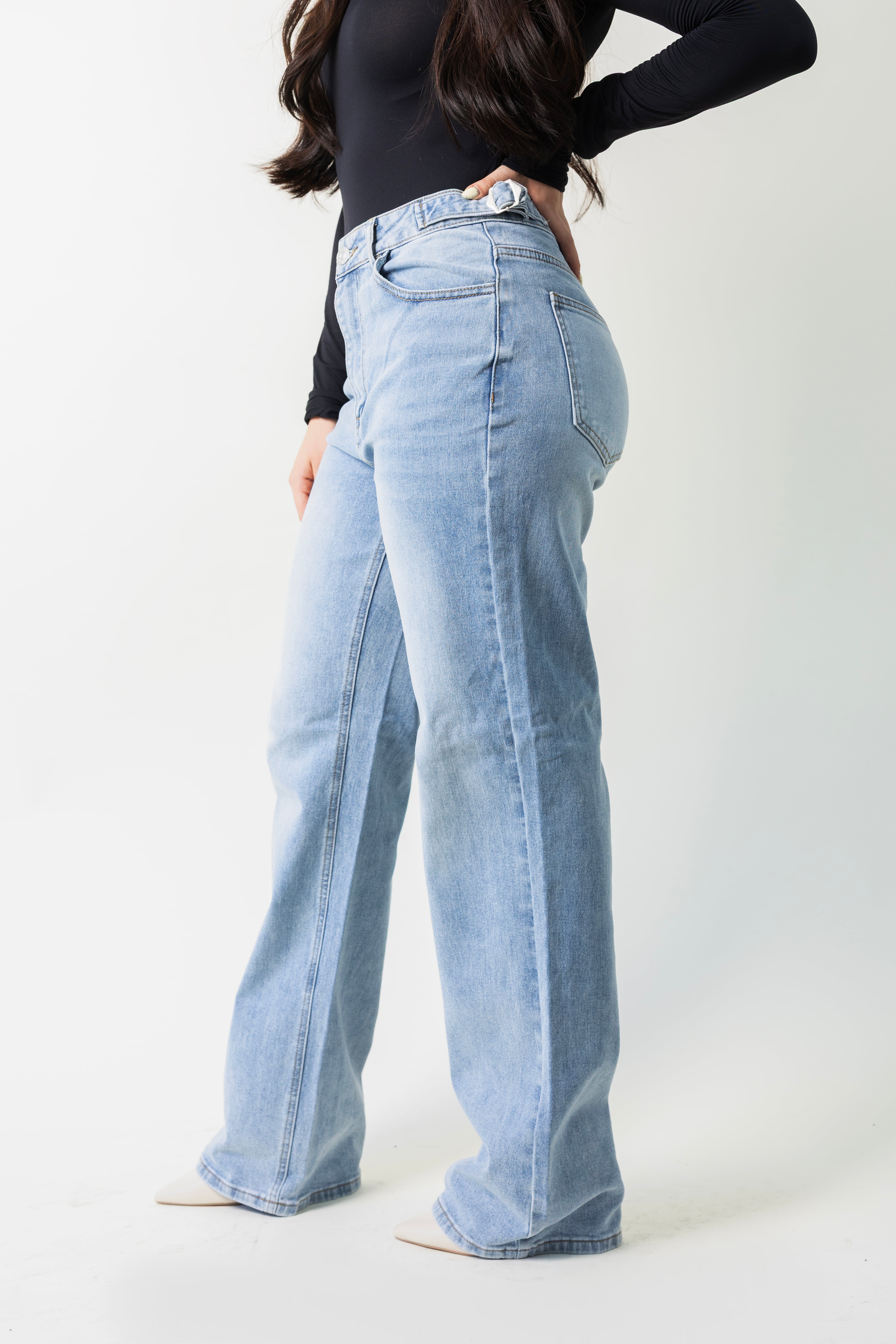 Detalle lateral del pantalon wide leg azul claro con hebillas en la cintura.
